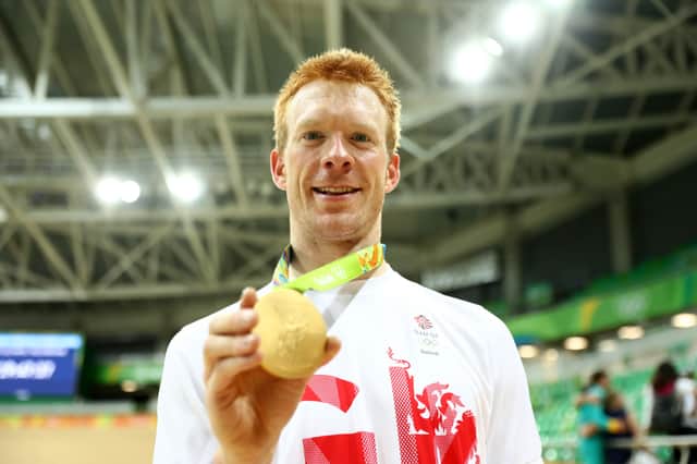 Gold medalist Edward Clancy of Team Great Britain poses for photographs after the medal ceremony for the Men's Team Pursuit on Day 7 of the Rio 2016 Olympic Games (Photo by Bryn Lennon/Getty Images)