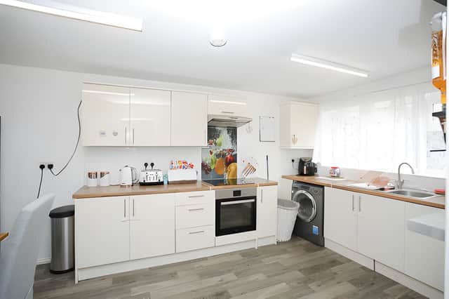 The fitted kitchen includes integrated appliances and space for dining