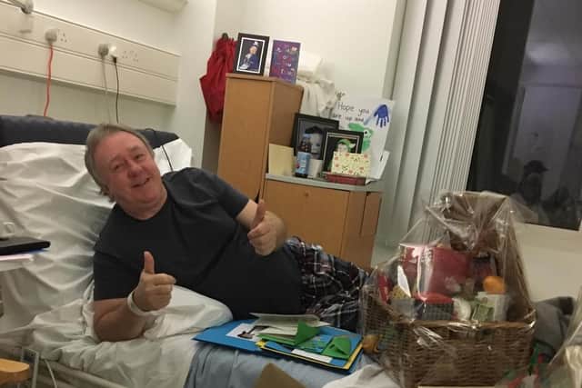 Derek Kingsford in his hospital bed with the gifts from Weedon Bec Primary School