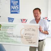 Jackson Grundy managing director David Jackson handsa cheque for 14,950 to ZoFinch from Northamptonshire Health Charity