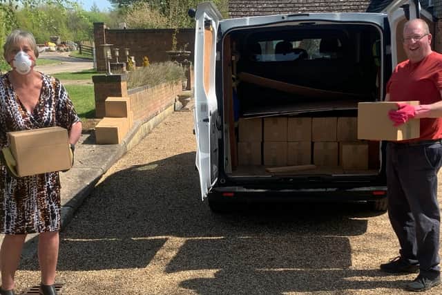Northamptonshire Community Larders founder Miranda Wixon and Martyn Dearsley of SNVB unload boxes