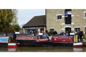 Representatives from Friends of Raymond, the Narrow BoatTrust, Braunston Marina and Friends of The Canal Museum on the three historic boats in Stoke Bruerne