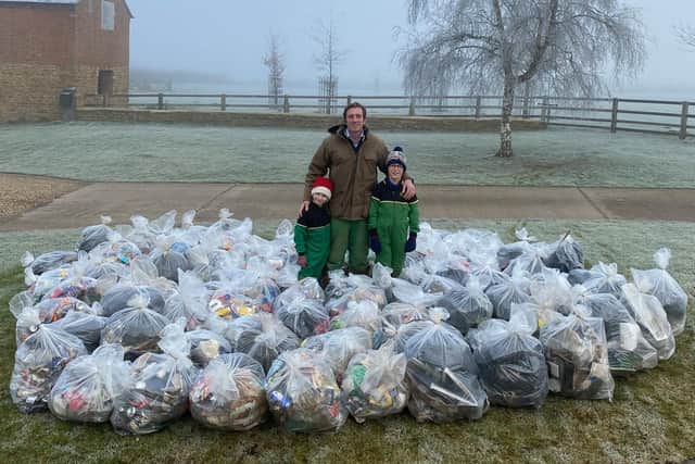 Joe Adams with his children Jessica, seven, and Henry, eight, who helped him sort the bags of rubbish collected from the B4039 outside Daventry