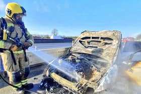Fire crews tackle the blazing BMW on the M1 yesterday. Photos: NFRS Mereway