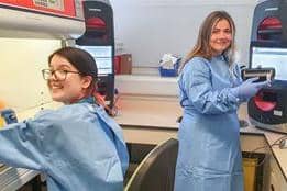 Lab technicians Charlotte and Eleanor use the new machines Credit: NGH