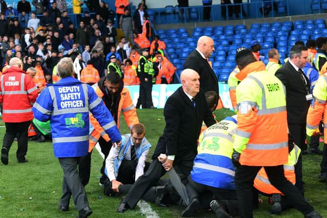 Stewards attempt to deal with trouble during the Championship match at Elland Road