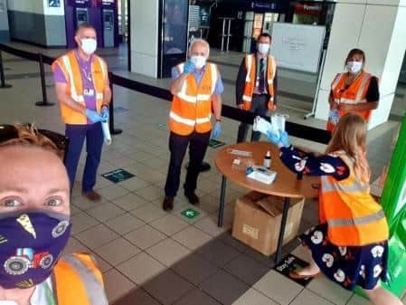 Station staff hand out masks  but most passengers are bringing their own