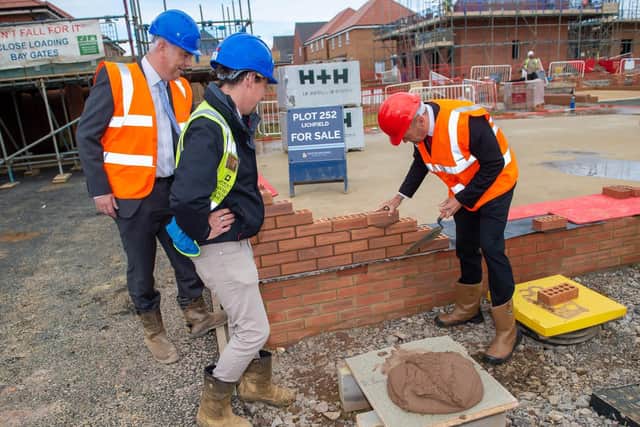 Chris Heaton-Harris laying a brick with contracts manager Kyle Shelton and
managing director John Dillon