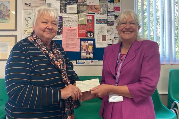 Barbara Edmunds presents Age UK Northamptonshire trustee Ann Battom with a cheque for £200