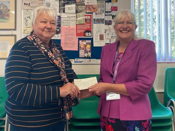 Barbara Edmunds presents Age UK Northamptonshire trustee Ann Battom with a cheque for £200