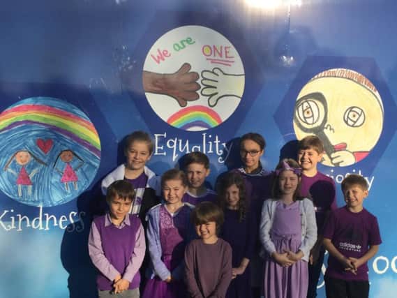 Liliane (third from left) wears purple with her friends at school.