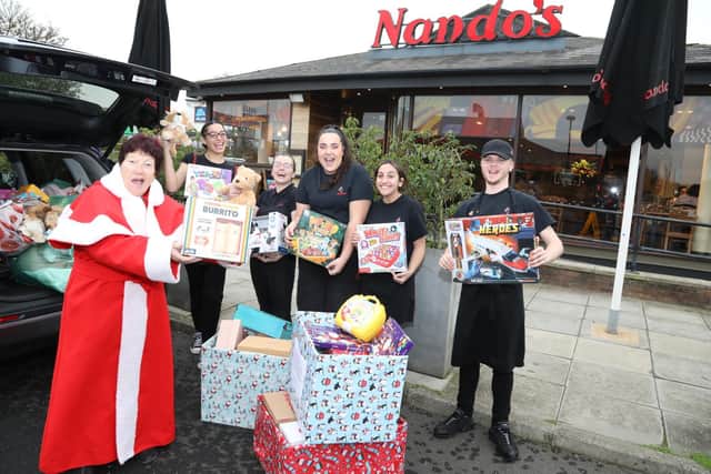 Mother Christmas - Jeanette Walsh with staff from Nando's Kettering Leah, Jade, Marcella, Nisha and Lewis