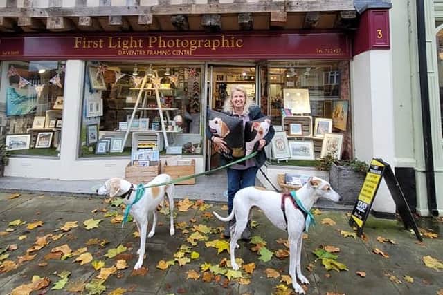 Dawn with her dogs showing off some of the Christmas presents available in her shop.