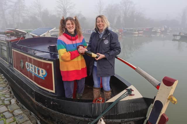 Barunston Marina Narrowboat Sales Manager Victoria Garfield presents circus performer Finley Guy with a bottle of Prosecco following her purchase of narrowboat CHIP – the marina’s first completed sale of 2022.