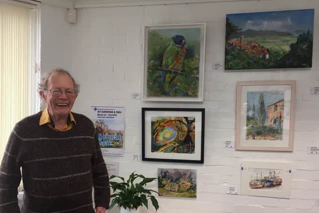 Norman How with some of his paintings.