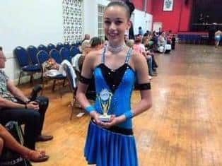 Emily with one of her many dancing awards.