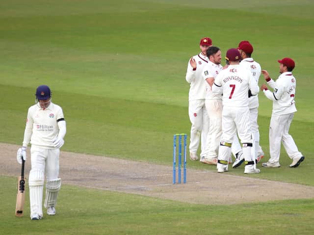 Simon Kerrigan is congratulated by his Northants team-mates after taking one of his three wickets against Lancashire (Pictures: Peter Short)