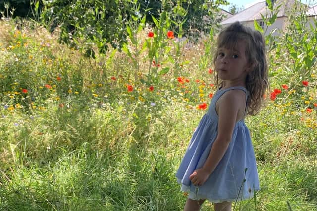 Wild child in the flowers.