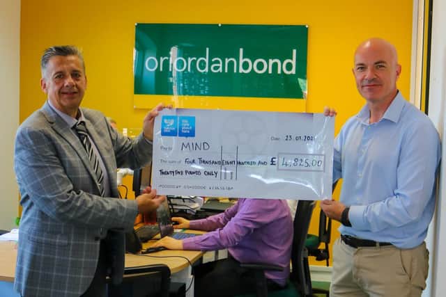 Matthew Bird handing over the cheque to the charity.