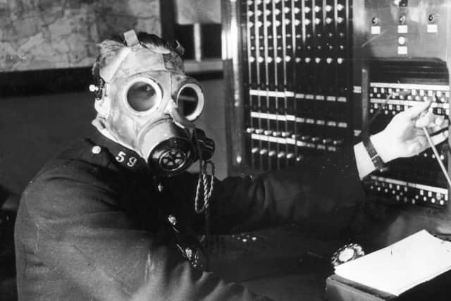 An operator wears a gas mask.