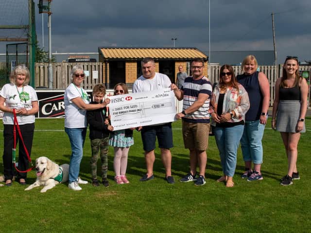 Darren and Stuart Hobbs hand over the cheque to Dogs for Good.
Picture: Richard Nunney.