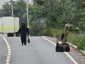 A person in a bomb disposal suit and a robot have been spotted on the A5 near Towcester, which remains closed for a police incident