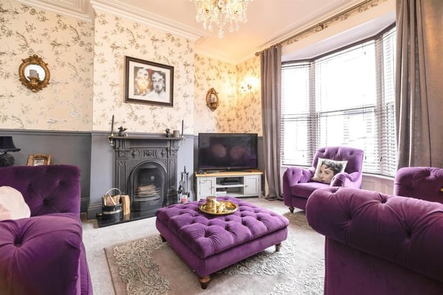The cosy lounge features period fireplace with open fire.
