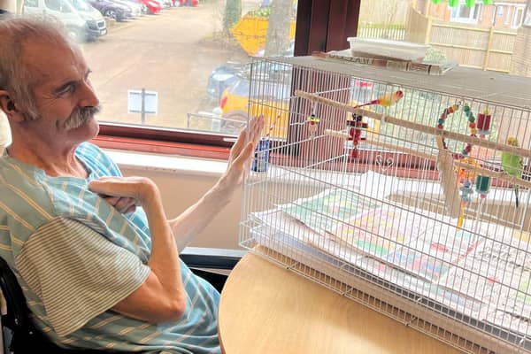Pytchley Court resident Robert Hasker with 'Fred' the budgie