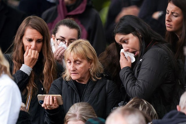 Mourners watched the funeral service on mobile phones while paying their respects
