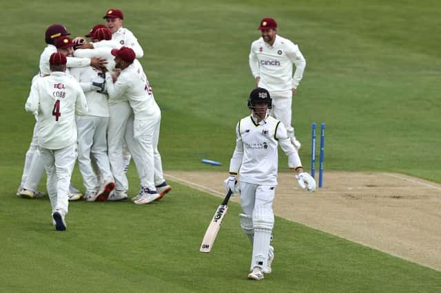 Ben Sanderson is mobbed by Northants team mates after bowling Ben Charlesworth