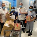 Staff on Dryden Ward at Northampton General Hospital receiving Christmas gifts for their patients on Christmas day.