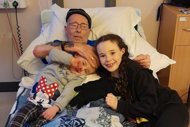 Dave Wellman pictured with his granddaughters, Cassidy and Frankie, in a hospital.