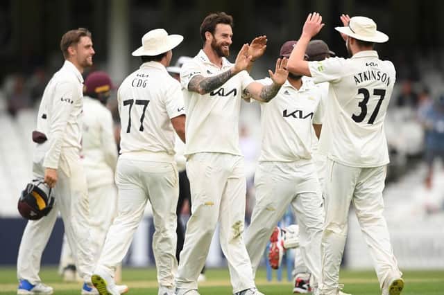 Surrey's Jordan Clark celebrates taking the wicket of Lewis McManus at the Kia Oval
