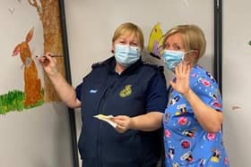 Team members Vivien Walton (left) and Samantha Conway decorate the new children’s area of the Moulton Park vaccination centre.