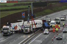 Cranes lift the stricken lorry upright following a crash which closed the M1 near junction 16 at just before 8am on Wednesday