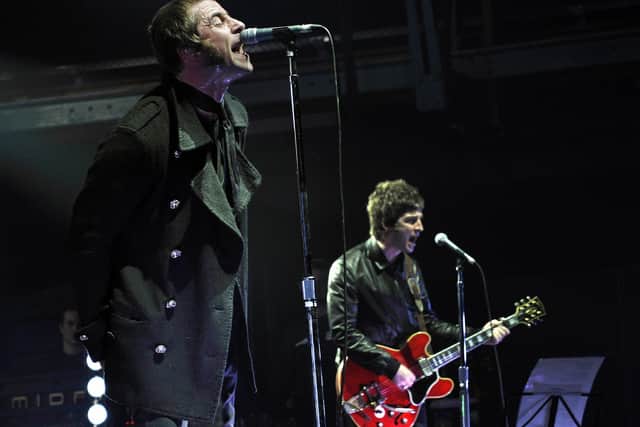 Liam and Noel Gallagher (R) of the real band Oasis. JOERG KOCH/DDP/AFP via Getty Images)