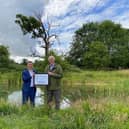 Robert James, Project Director for Bellway, receiving the Gold Supporter Award from Dr Tom Tew, CEO of NatureSpace Partnership, at a compensation site in Oxfordshire