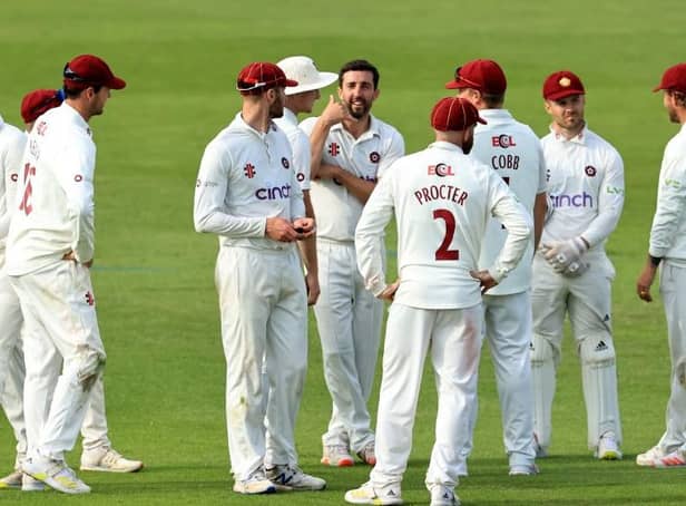 Ben Sanderson celebrates with his Northants team-mates after taking the wicket of Daniel Bell-Drummond