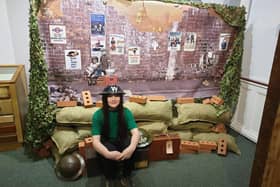 Ava Bazeley, a local school student, pictured in front of the World War Two bomb site display, in the museum.
