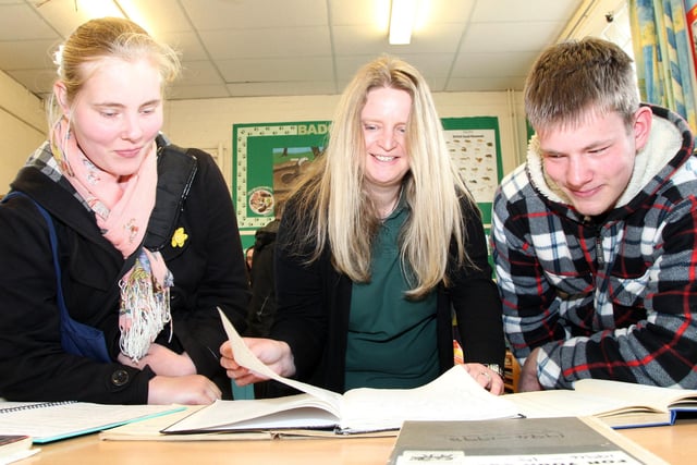 Centre manager Esther Bushell pictured helping Emma and Kieran Meakins look through the old visitor books for their entries from 2004.