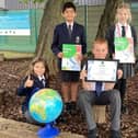 Falconer’s Hill Academy pupils pictured holding the Silver Primary Geography Quality Mark (PGQM) award.