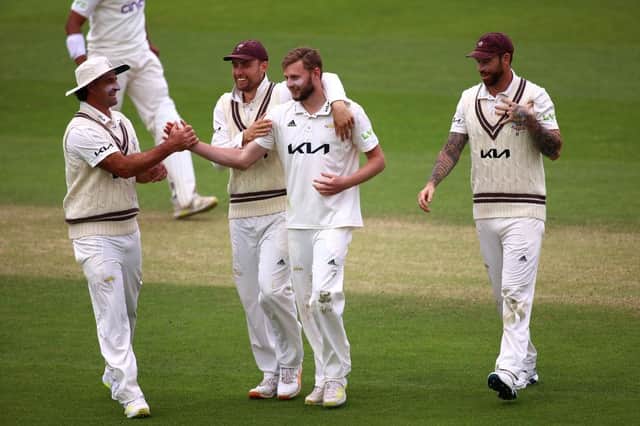 Gus Atkinson of Surrey celebrates with team mates after taking the keywicket of Luke Procter
