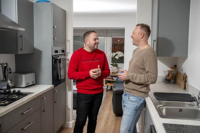 Connor and Adam Perry like the practical kitchen with plenty of storage space in their new home 