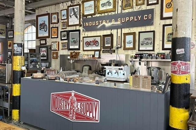 Industry & Supply now has a cafe and showroom open in Building 14 at Weedon Depot. It is bursting with automotive artwork and merchandise, and visitors can relax and enjoy a drink during their visit. With 2,000 square feet of space, they have their 1954 Thames Van inside – soon to be joined by others.