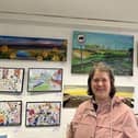 Anna pictured at Long Buckby Library and Hub with her artwork.