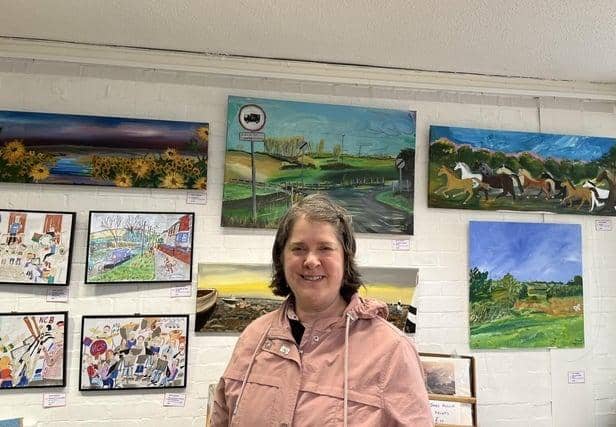 Anna pictured at Long Buckby Library and Hub with her artwork.