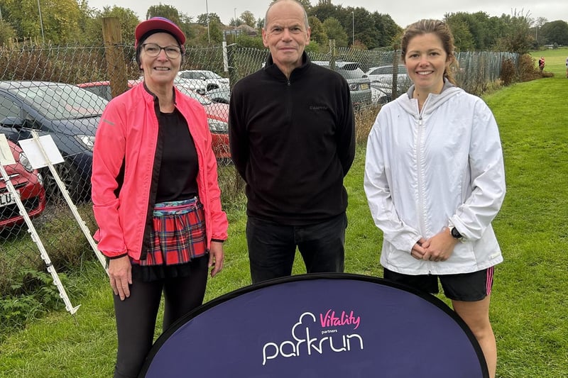 Karen Balloch, the Daventry parkrun co-event director, pictured with her husband, James, and daughter, Louise, after finishing her 100th event.