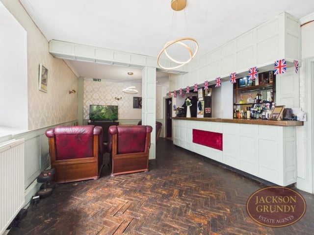The living room features a built-in bar area
