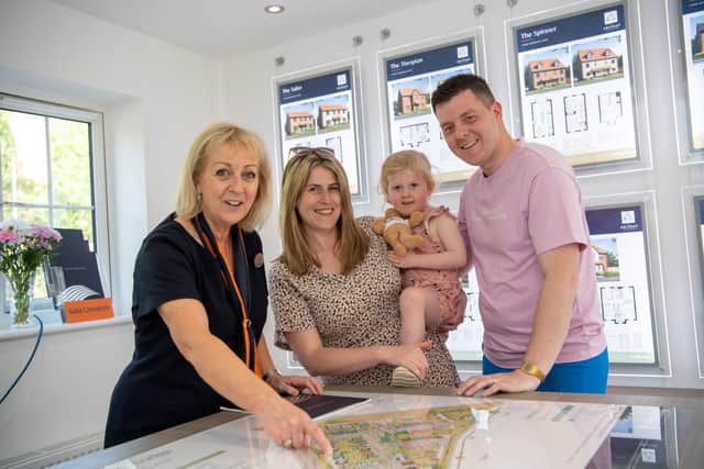 Bellway sales advisor Lynne Muxlow with visitors Lucy, Elise, 3, and Ross inside the sales office 