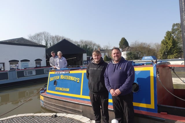 Father and son narrowboat painters Dave and Aaron Bishop with proud owners Keith and Jill Astley.